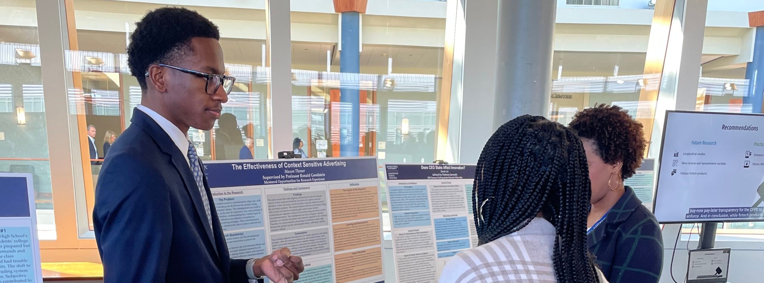 students presenting their research at the research symposium
